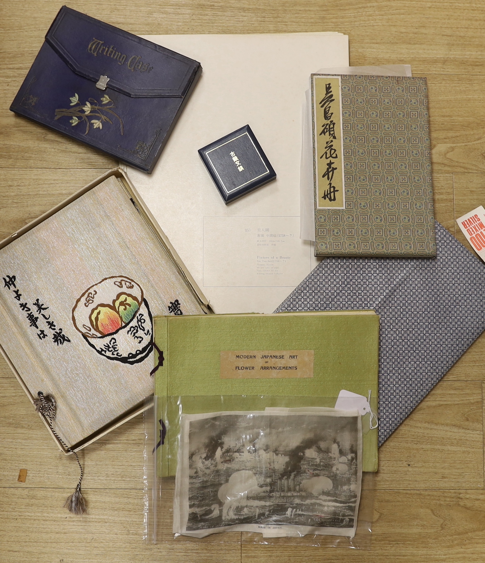 A Chinese album of flower prints Wu Changshuo, published by Cao Bai, 1972, a book of Modern Japanese Art of Flower Arrangements, a fine silk commemorative handkerchief with a printed panel depicting the surrender in 1905